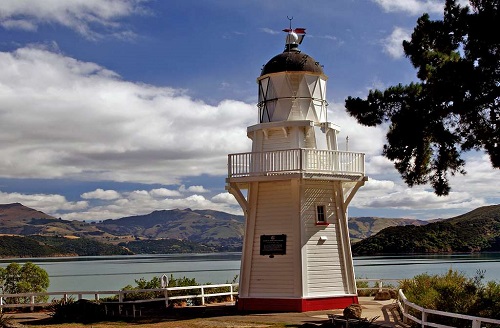 Lighthouse overlook water and mountains