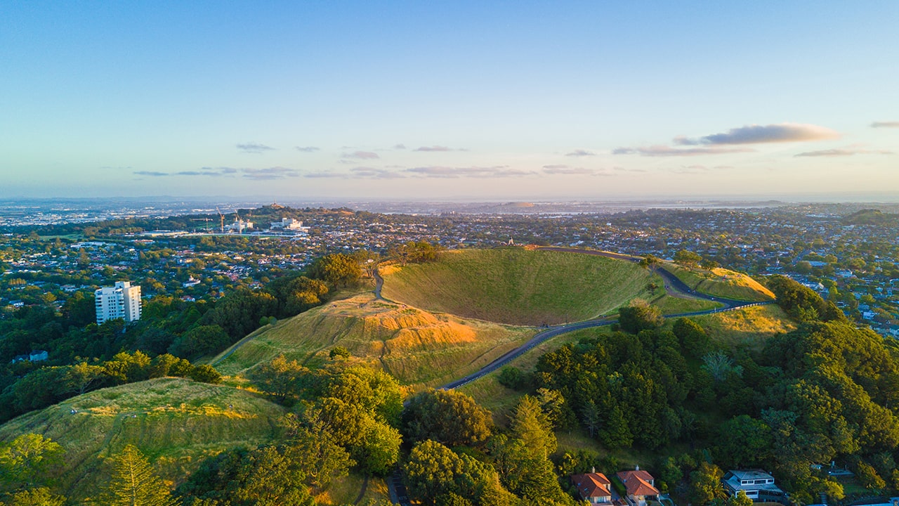 A green hill overlooking a city 