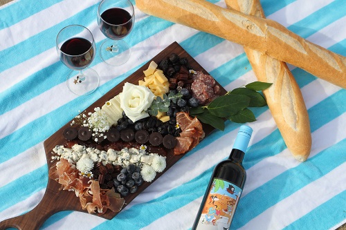 Bread, cheese, snacks and wine on a table