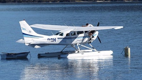 Light aircraft hovering over lake