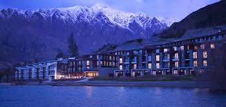 A building with many windows against a mountain backdrop